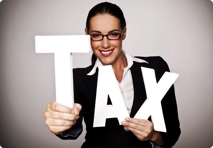 girl holding a TAX sign